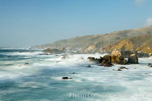 Waves blur as they break over the rocky shoreline of Big Sur
