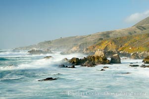 Waves blur as they break over the rocky shoreline of Big Sur