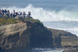 People watch giant surf breaking at Boomers / Alligator Head near La Jolla Cove.  Giant surf and big waves nail Southern California, December 21, 2005