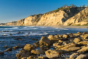 Black's Beach sea cliffs, sunset, looking north from Scripps Pier with Torrey Pines State Reserve in the distance, La Jolla, California