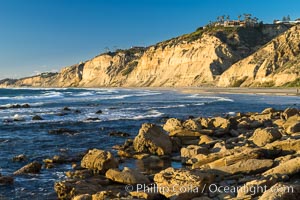 Black's Beach sea cliffs, sunset, looking north from Scripps Pier with Torrey Pines State Reserve in the distance, La Jolla, California