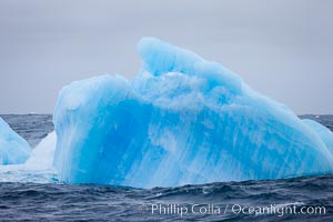 A blue iceberg.  Blue icebergs are blue because the ice from which they are formed has been compressed under such enormous pressure that all gas (bubbles) have been squeezed out, leaving only solid water that takes on a deep blue color, Scotia Sea