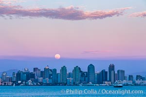 Blue Moon at Sunset over San Diego City Skyline.  The third full moon in a season, this rare "blue moon" rises over San Diego just after sundown
