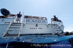 Crew of the dive boat Horizon wait at the stern to help divers out of the water, Guadalupe Island (Isla Guadalupe)