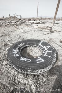 Bombay Beach, lies alongside and below the flood level of the Salton Sea, so that it floods occasionally when the Salton Sea rises.  A part of Bombay Beach is composed of derelict old trailer homes, shacks and wharfs, slowly sinking in the mud and salt, Imperial County, California