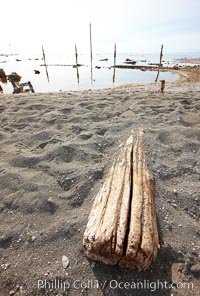 Bombay Beach, lies alongside and below the flood level of the Salton Sea, so that it floods occasionally when the Salton Sea rises.  A part of Bombay Beach is composed of derelict old trailer homes, shacks and wharfs, slowly sinking in the mud and salt, Imperial County, California