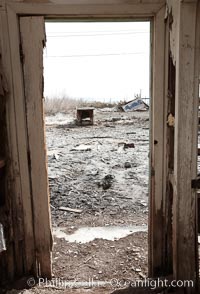 Bombay Beach, lies alongside and below the flood level of the Salton Sea, so that it floods occasionally when the Salton Sea rises.  A part of Bombay Beach is composed of derelict old trailer homes, shacks and wharfs, slowly sinking in the mud and salt, Imperial County, California