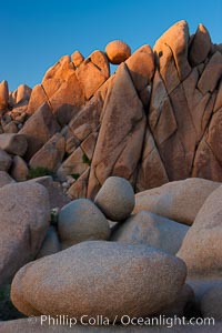 Boulders and sunset in Joshua Tree National Park.  The warm sunlight gently lights unusual boulder formations at Jumbo Rocks in Joshua Tree National Park, California