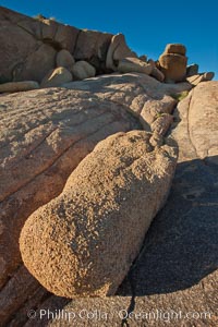 Boulders and sunset in Joshua Tree National Park.  The warm sunlight gently lights unusual boulder formations at Jumbo Rocks in Joshua Tree National Park, California