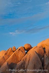 Boulders and sunset in Joshua Tree National Park.  The warm sunlight gently lights unusual boulder formations at Jumbo Rocks in Joshua Tree National Park, California