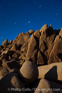 Boulders and stars, moonlight in Joshua Tree National Park. The moon gently lights unusual boulder formations at Jumbo Rocks in Joshua Tree National Park, California