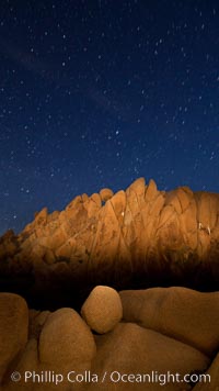 Boulders and stars, moonlight in Joshua Tree National Park. The moon gently lights unusual boulder formations at Jumbo Rocks in Joshua Tree National Park, California