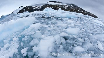 Brash ice and pack ice in Antarctica.  Brash ices fills the ocean waters of Cierva Cove on the Antarctic Peninsula.  The ice is a mix of sea ice that has floated near shore on the tide and chunks of ice that have fallen into the water from nearby land-bound glaciers