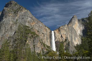 Bridalveil Falls drops 620 through a hanging valley, shown here at peak water flow in spring months from deep snowpack and warm weather melt.  Yosemite Valley, Yosemite National Park, California