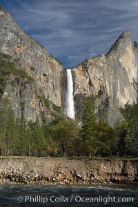 Bridalveil Falls drops 620 through a hanging valley, shown here at peak water flow in spring months from deep snowpack and warm weather melt.  Yosemite Valley, Yosemite National Park, California