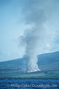 West Maui and smoke from burning cut sugar cane.  Cane fields are often burned to clear cane cuttings, which produces huge amounts of smoke and ash