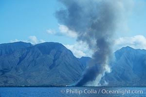 West Maui and smoke from burning cut sugar cane.  Cane fields are often burned to clear cane cuttings, which produces huge amounts of smoke and ash