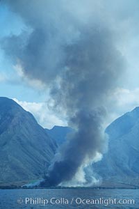 West Maui and smoke from burning cut sugar cane.  Cane fields are often burned to clear cane cuttings, which produces huge amounts of smoke and ash