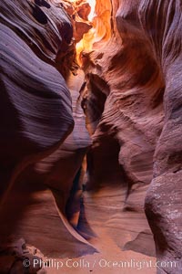 Canyon X, a spectacular slot canyon near Page, Arizona.  Slot canyons are formed when water and wind erode a cut through a (usually sandstone) mesa, producing a very narrow passage that may be as slim as a few feet and a hundred feet or more in height