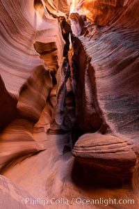 Canyon X, a spectacular slot canyon near Page, Arizona.  Slot canyons are formed when water and wind erode a cut through a (usually sandstone) mesa, producing a very narrow passage that may be as slim as a few feet and a hundred feet or more in height