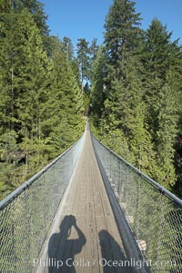 Capilano Suspension Bridge, 140 m (450 ft) long and hanging 70 m (230 ft) above the Capilano River.  The two pre-stressed steel cables supporting the bridge are each capable of supporting 45,000 kgs and together can hold about 1300 people, Vancouver, British Columbia, Canada