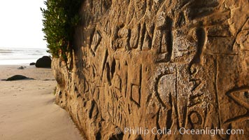 Graffiti is carved into soft sandstone cliffs at the beach, Carlsbad, California