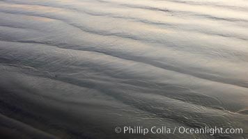 Patterns in the sand on a flat sandy beach at the water's edge, Carlsbad, California