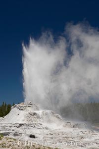 Castle Geyser erupts, reaching 60 to 90 feet in height and lasting 20 minutes.  While Castle Geyser has a 12 foot sinter cone that took 5,000 to 15,000 years to form, it is in fact situated atop geyserite terraces that themselves may have taken 200,000 years to form, making it likely the oldest active geyser in the park. Upper Geyser Basin, Yellowstone National Park, Wyoming