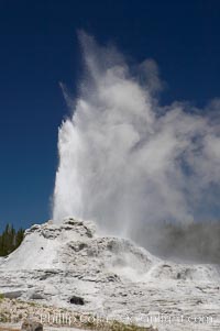 Castle Geyser erupts, reaching 60 to 90 feet in height and lasting 20 minutes.  While Castle Geyser has a 12 foot sinter cone that took 5,000 to 15,000 years to form, it is in fact situated atop geyserite terraces that themselves may have taken 200,000 years to form, making it likely the oldest active geyser in the park. Upper Geyser Basin, Yellowstone National Park, Wyoming