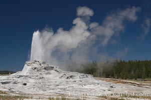 Castle Geyser erupts, reaching 60 to 90 feet in height and lasting 20 minutes.  While Castle Geyser has a 12 foot sinter cone that took 5,000 to 15,000 years to form, it is in fact situated atop geyserite terraces that themselves may have taken 200,000 years to form, making it likely the oldest active geyser in the park. Upper Geyser Basin, Yellowstone National Park, Wyoming