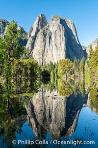 Cathedral Rocks reflected in a meadow flooded by the Merced River, historical snowmelt following record snowfall floods Yosemite Valley in May 2023, Yosemite National Park, California