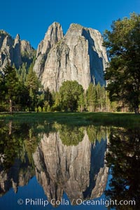 Cathedral Rocks at sunrise, reflected in a spring meadow flooded by the Merced River, Yosemite National Park, California