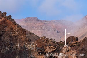 Lighthouse and cross mark the site of a small fishing shack and old chapel and prison near the north end of Guadalupe Island (Isla Guadalupe)