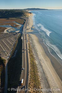 Coast Highway 101, looking south from Del Mar, with Los Penasquitos Marsh on the left and the cliffs of Torrey Pines State Reserve and La Jolla in the distance.
