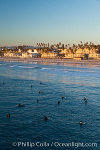 The coast of Oceanside California, waves and surfers, beach houses, just before sunset, winter, looking north, Oceanside Pier