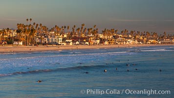 The coast of Oceanside California, waves and surfers, beach houses, just before sunset, winter, looking south, Oceanside Pier