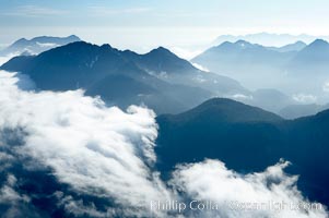 Coastal mountains and clouds, rising above Bedwell Sound (hidden by clouds) and Clayoquot Sound, near Tofino on the west coast of Vancouver Island