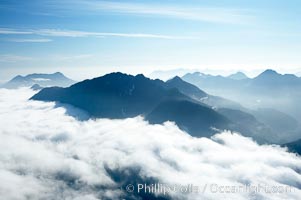 Coastal mountains and clouds, rising above Bedwell Sound (hidden by clouds) and Clayoquot Sound, near Tofino on the west coast of Vancouver Island