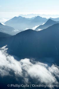 Coastal mountains and clouds, rising above Bedwell Sound (hidden by clouds) and Clayoquot Sound, near Tofino on the west coast of Vancouver Island