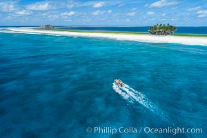 Dive Boat Passes Over Coral Reef at Clipperton Island in the Eastern Tropical Pacific, Aerial Photo. Clipperton has healthy, beatiful coral reefs.  The white beaches are composed of white coralline rubble. Clipperton Island, a minor territory of France also known as Ile de la Passion, is a spectacular coral atoll in the eastern Pacific. By permit HC / 1485 / CAB (France)