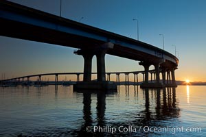 Coronado Bridge, linking San Diego to Coronado, sunrise, viewed from Coronado Island. San Diego Coronado Bridge, known locally as the Coronado Bridge, links San Diego with Coronado, California. The bridge was completed in 1969 and was a toll bridge until 2002. It is 2.1 miles long and reaches a height of 200 feet above San Diego Bay