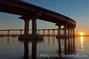 Coronado Bridge, linking San Diego to Coronado, sunrise, viewed from Coronado Island. San Diego Coronado Bridge, known locally as the Coronado Bridge, links San Diego with Coronado, California. The bridge was completed in 1969 and was a toll bridge until 2002. It is 2.1 miles long and reaches a height of 200 feet above San Diego Bay