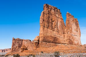 Courthouse Towers, narrow sandstone fins towering above the surrounding flatlands. The Organ is in the foreground, and Tower of Babel in the distance, Arches National Park, Utah