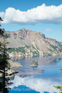 Crater Lake and Phantom Ship. Crater Lake is the six-mile wide lake inside the collapsed caldera of volcanic Mount Mazama, Crater Lake National Park, Oregon