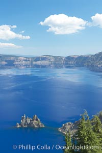 Crater Lake and Phantom Ship. Crater Lake is the six-mile wide lake inside the collapsed caldera of volcanic Mount Mazama, Crater Lake National Park, Oregon