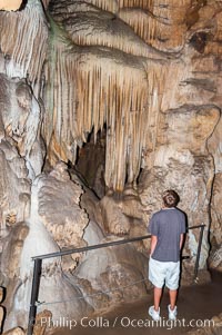 Visitors admire the Pipe Organ formation of calcite flowstone and cave curtains, Crystal Cave, Sequoia Kings Canyon National Park, California