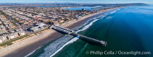 Aerial Photo of Crystal Pier, 872 feet long and built in 1925, extends out into the Pacific Ocean from the town of Pacific Beach. Panoramic photo