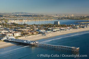 Crystal Pier, 872 feet long and built in 1925, extends out into the Pacific Ocean from the town of Pacific Beach.  Mission Bay and downtown San Diego are seen in the distance