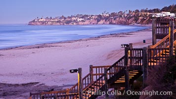 The Crystal Pier and Pacific Ocean at sunrise, dawn, waves blur as they crash upon the sand.  Crystal Pier, 872 feet long and built in 1925, extends out into the Pacific Ocean from the town of Pacific Beach