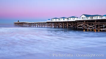 The Crystal Pier and Pacific Ocean at sunrise, dawn, waves blur as they crash upon the sand.  Crystal Pier, 872 feet long and built in 1925, extends out into the Pacific Ocean from the town of Pacific Beach. California, USA, natural history stock photograph, photo id 27243